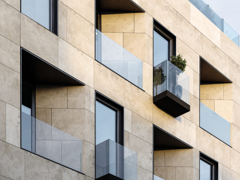 AQSO arquitectos office. The stunning facade of the maragato building is composed of balconies and bay windows, combining stone cladding with metal frames and aluminium composites.