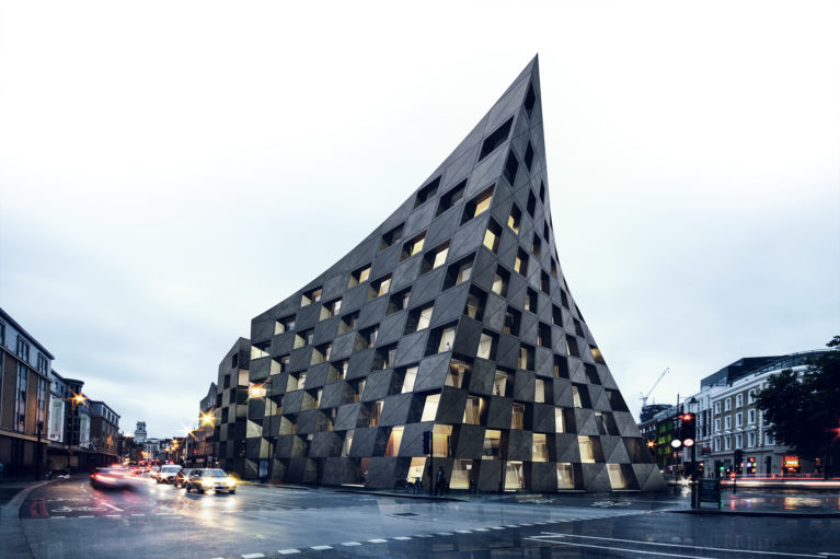 AQSO arquitectos office. View of the hotel from the intersection of the main streets. The turned silhouette of the volume distorts the perspective and provides an iconic image of the building.