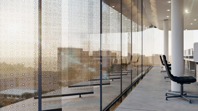 AQSO arquitectos office. Laminated glass slats with metal mesh with arabesque motifs seen from inside the offices.