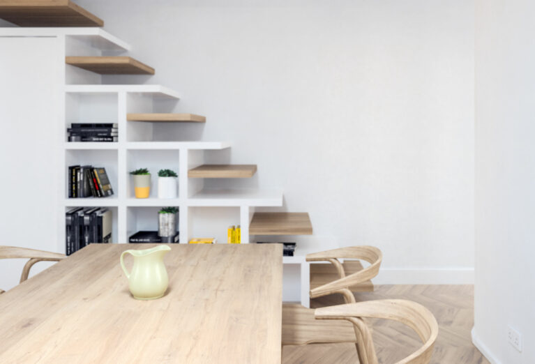 AQSO arquitectos office. The unique design of the stairs provides a bookcase in front of the dining room and conceals a small toilet under the steps.