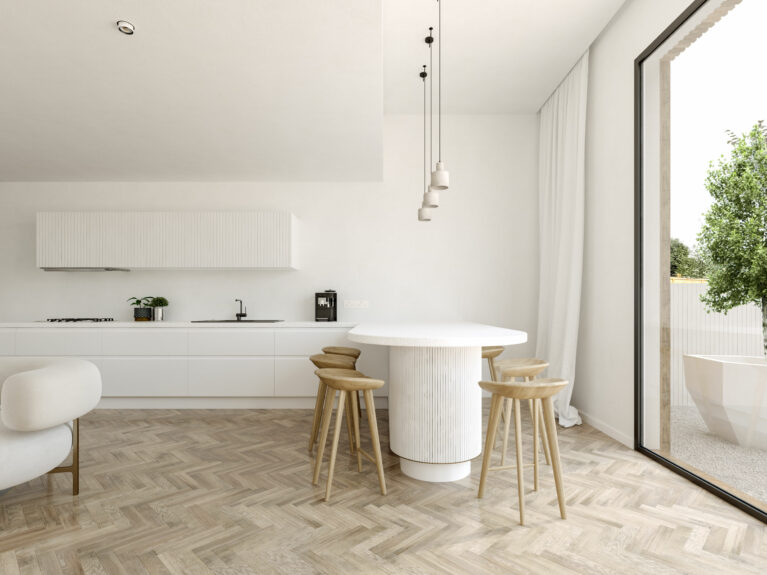 AQSO arquitectos office. The matt white kitchen units add brightness. The worktop ends in a peninsula with stools that serves as a dining table.