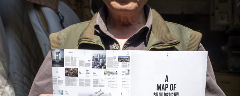 A map of hutopolis, hutong habitant holding the book. Image by LAVA